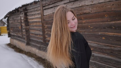 Fototapeta premium A young schoolgirl with no cues poses in winter.