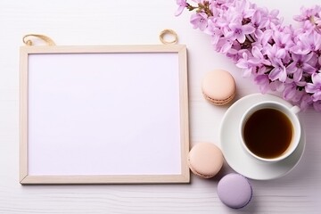 Fototapeta na wymiar A bouquet of lilacs, cup of tea, love note and macarons on a white wooden table