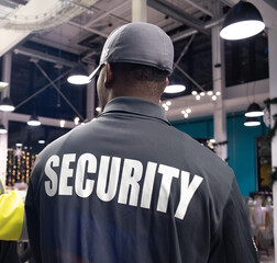 Security guard conducting access control, traffic control, and parking enforcement duties around a community building.