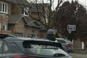 Security vehicle is stationed on the street in order to protect people and houses.