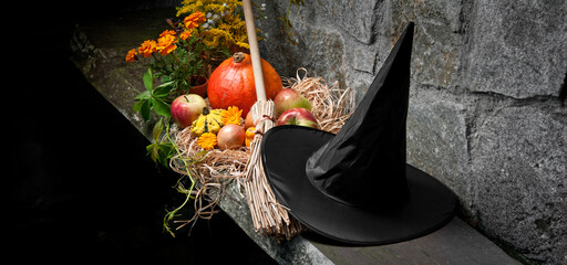 halloween still life with pumpkins and witch hat and broom