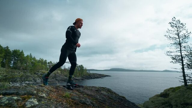 Intensive Workout Of Athletic Man At Top Of Mount, Jock Man Squatting With Lunge, Tensing Legs