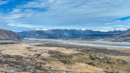 The dry arid alpine Hakatere conservation park bordered by the snow capped southern alps mountain range © Stewart