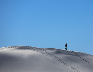 Walking and thinking along white sand dunes 