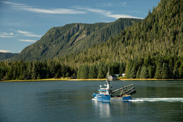 Fishing boat headed out to fish for salmon; Inside Passage; Alaska - obrazy, fototapety, plakaty