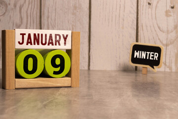 09 January on wooden grey cubes. Calendar cube date 9 January. Concept of date. Copy space for text...