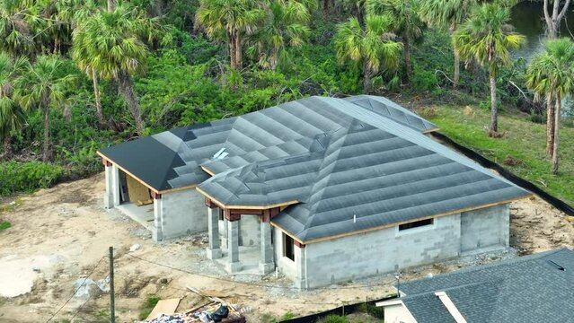 Rooftop covered with asphalt underlayment layer ready for installation of shingles on new house. Roof construction. Florida real estate development