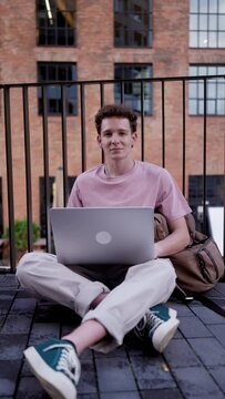 Gen Z student working on laptop after lecture on campus. Young stylish zoomer studiing outdoors. Importance of education of gen Z.
