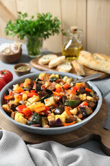Delicious ratatouille in frying pan on table, space for text