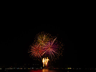 Fireworks Night Sky Abstract Black Background Light Travel Party Fire Happy New Year Celebration Red Orange Color Card Mockup Holidays Effect Light Bright River Sea Scene, Festival Pattaya Thainland.