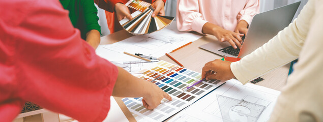 Professional designer team brainstorms material colors, while the project manager suggests a...