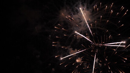 Fireworks draw amazing pattern of sparkling blasts in black night sky. Fireworks dazzling display...