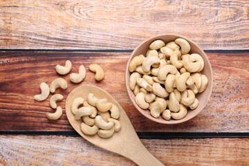 Tasty cashew nuts on wooden table, flat lay