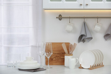 Clean dishes on light table in kitchen