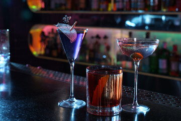 Different fresh alcoholic cocktails on counter in bar