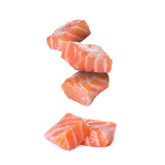 Pieces of salmon falling on white background