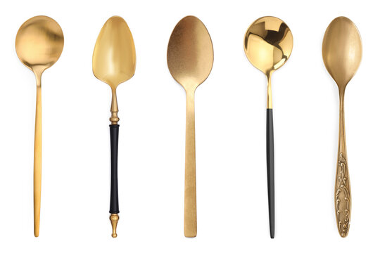 Different stylish golden spoons on white background