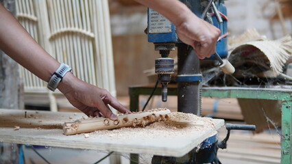 a worker with a wood drill