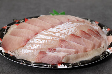 Fresh white raw fish and red raw fish. Raw fish on a takeaway plate.
