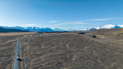 Agricultural pasture and grazing countryside  inland from Lake Tekapo with the snow covered...