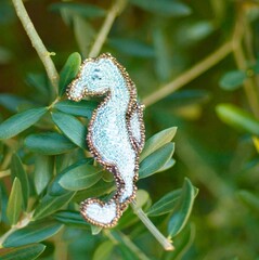A beautiful sparkling brooch with beads embroidery in the shape of a seahorse. White background template that anyone can easily create New Year's cards. botanical background__olive