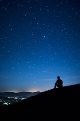 a man silhouette on the mountain with a milky way at night under the stars, galaxy, romance, thinker in the nature