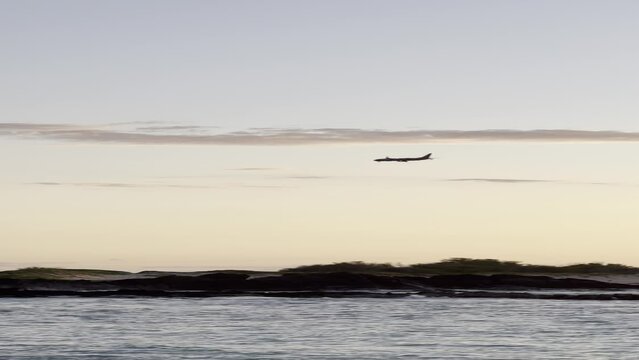 Plane Landing Over the Beach
