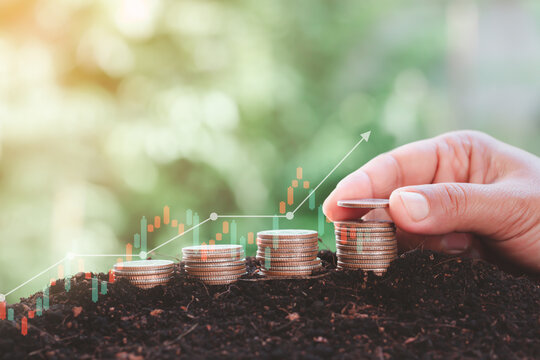 hand people arranging coins for saving money and a graph comparing the growth of savings concept with vintage background.