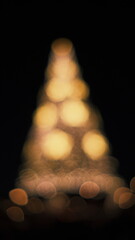 bokeh glow of christmas tree lights in the background 