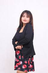Beautiful Asian Indonesian girl in a casual professional office skirt, cheerful smile, crooked...