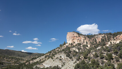 Naklejka premium Cumulus clouds over mesa butte in Little Book Cliffs National Monument near Grand Junction Colorado United States