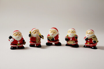 Santa Claus Orchestra Figures. They perform with a violin, a xylophone, an accordion, a drum, and a...