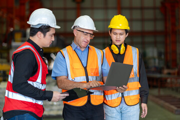 Team of diversity worker inspecting inside the steel manufacturing factory while listening to...