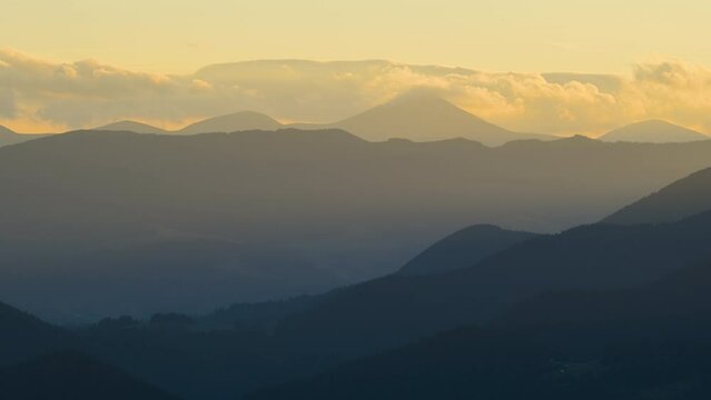 Time-lapse of old peasant homes on hillside. Amazing mountain landscape. Colorful sunset in wild national park highlands with dark spruce woods