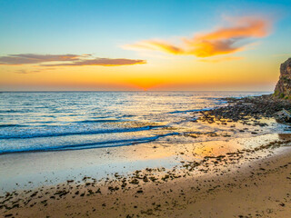 Fototapeta na wymiar Sunrise at the seashore with clouds