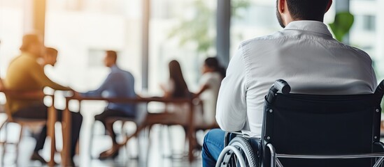 Young college student in wheelchair participating in group discussion, copy space - viewed from behind.