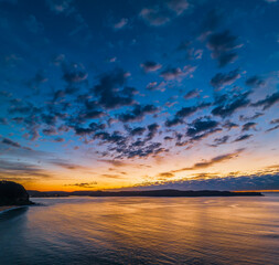 Fototapeta premium Aerial sunrise seascape with pretty cloud filled sky