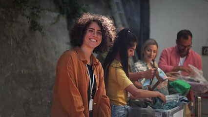Volunteers sorting of clothes collected in a charity. Charitable work concept.