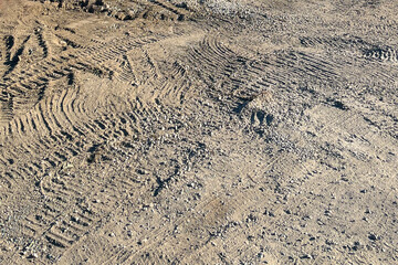 Fototapeta na wymiar Tire tracks in the dry dirt ground