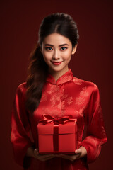 Happy Chinese new year, Asian young woman holding gift box wearing traditional cheongsam dress on red background, Generative AI
