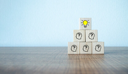 Concept creative idea and innovation. wooden cube block with head human symbol and light bulb icon