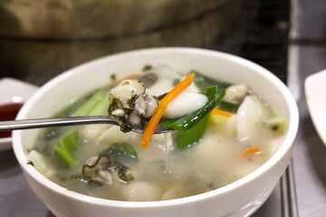 Korean food. oyster rice cake soup