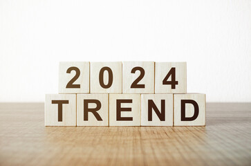 2024 Action Plan. Wooden figures of people and wooden cubes with the word Trends 2024