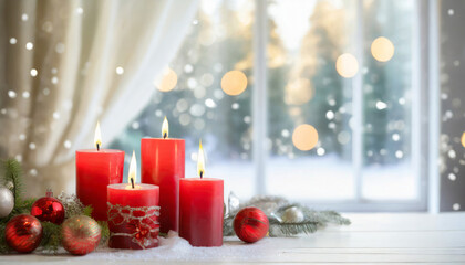 Closeup of four red candles displayed on a table by winter scenery window. Festive Christmas decorations. Copy space.
