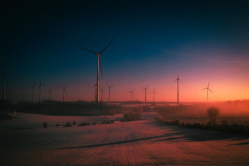 wind turbines at winter sunset