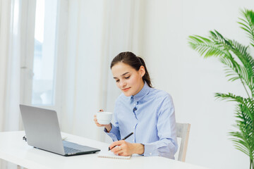 Woman at desk working on laptop online financial business from office