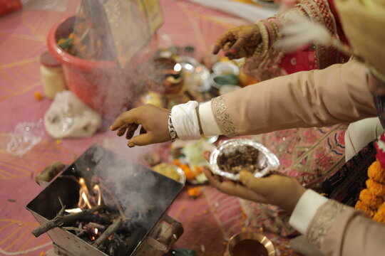 A couple offering prayer material to the sacred fire as a symbol of respect to God in Hindu religion