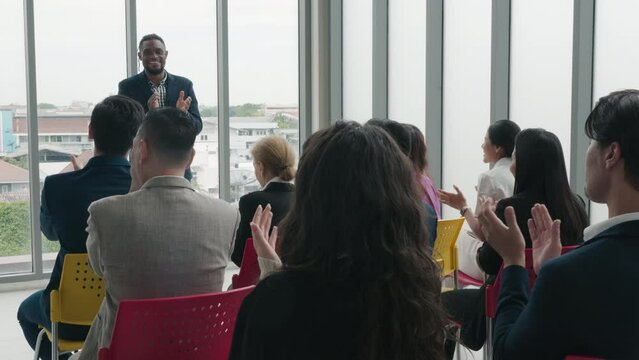 Commendable achievement Diverse business team claps hands, acknowledging the success of a new product in a vibrant office setting. Collaborative spirit, motivation, and teamwork shine through.