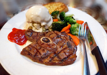 Fire grilled lamb served with mashed potatoes and veggies