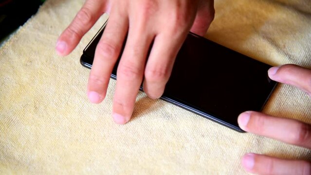 The man installing the smart phone screen protect flim